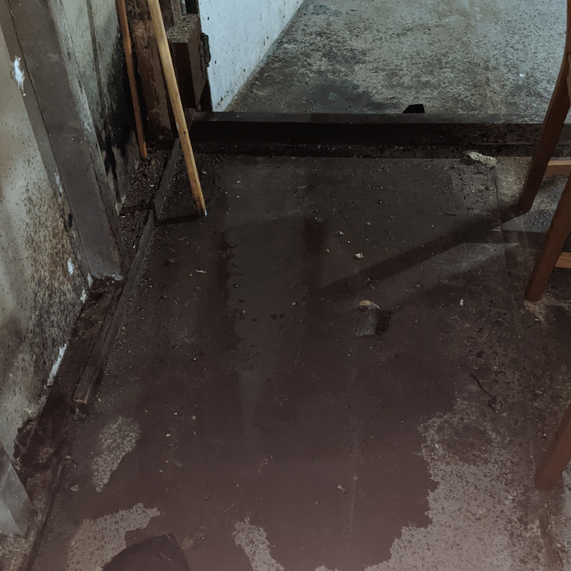 Water puddles on a basement floor.