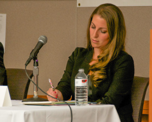 Kate Campanale, candidate for 17th Worcester Representative, prepares her comments during the MassLandlords.net Small Business Candidates' Night 2014.
