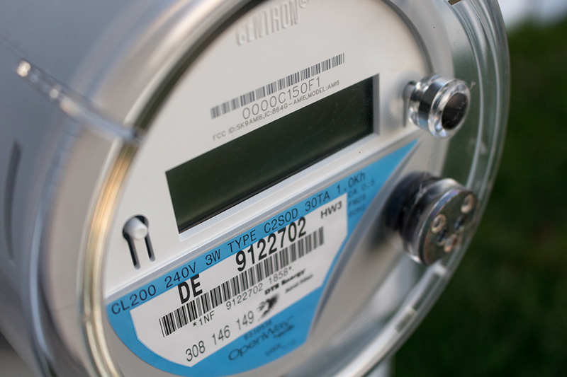 A close-up of a round residential electricity meter.