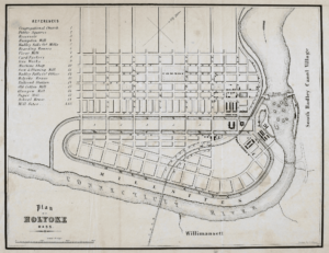 A map shows the grid of Holyoke streets nestled in among the Connecticut River. Canals cut into the city power mills and provide freight access.