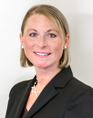 Attorney Melissa Gleick of The Law Office of Melissa A. Gleick, Esq. Attorney at Law, in dark suit with a bob haircut, pearl earrings and pearllike necklace