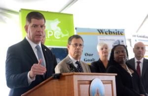Marty Walsh (left) speaks about housing production (which is fine) and the anti-displacement agenda, accompanied by Marc Draisen (second from left).