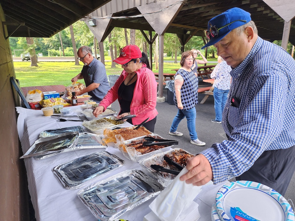 MWPOA members choosing food from the picnic buffet table