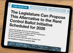 An image of an iPad has the cover of the white paper pulled up. The top has a banner that reads “Time Sensitive.” The headline reads “The Legislature can propose this alternative to the rent control ballot initiative scheduled for 2026.” Then it reads: “Current law already allows for rent stabilization. Here’s a White Paper on Chapter 40P Rent Stabilization. It’s a Practical Guide to Implementation. We give a sample ordinance. We give the sample Alternate Ballot Question text. The deadline to decide is January 2026.” An aerial photograph of a Massachusetts neighborhood is partially visible below.