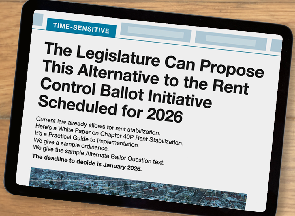 An image of an iPad has the cover of the white paper pulled up. The top has a banner that reads “Time Sensitive.” The headline reads “The Legislature can propose this alternative to the rent control ballot initiative scheduled for 2026.” Then it reads: “Current law already allows for rent stabilization. Here’s a White Paper on Chapter 40P Rent Stabilization. It’s a Practical Guide to Implementation. We give a sample ordinance. We give the sample Alternate Ballot Question text. The deadline to decide is January 2026.” An aerial photograph of a Massachusetts neighborhood is partially visible below.