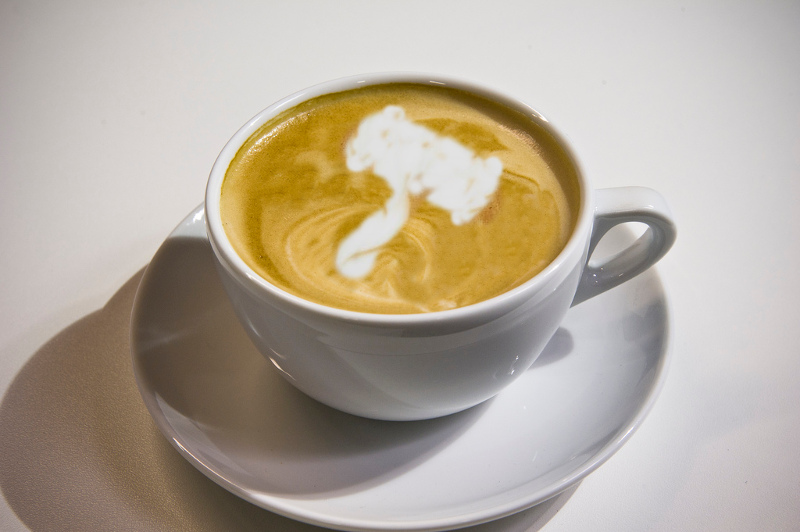 A latte showing a gavel shape painted in milk over the top. CC BY-SA MassLandlords derivative Jazzbobrown Wikipedia.