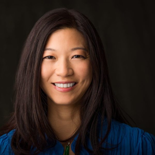 Jarling Ho wears her hair to shoulder length and smiles broadly in a professional headshot.