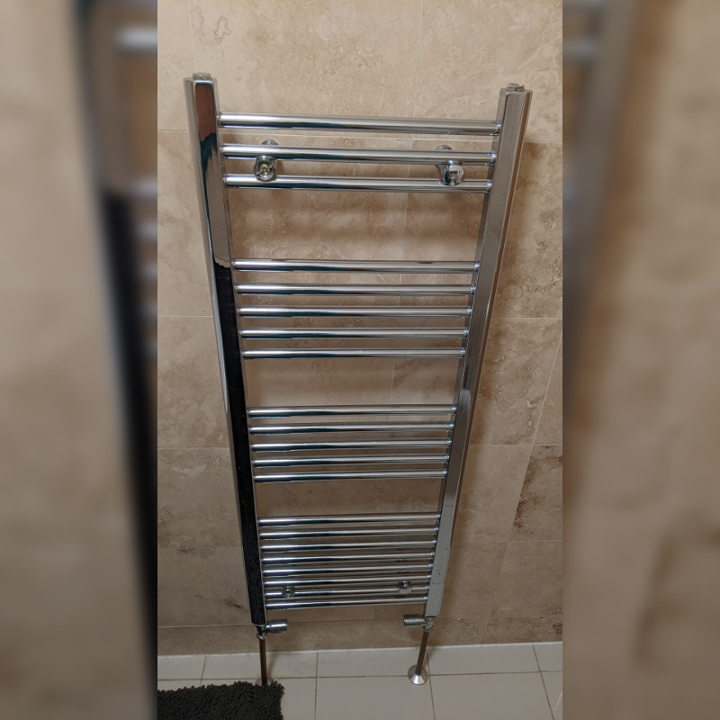 22 rungs of smooth metal rails lead up the bathroom wall like a ladder.