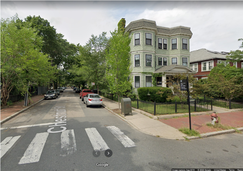 Google Maps screenshot of the intersection of Chestnut and Magazine streets in Cambridge. A three story house with two columns of large bay windows sits on the corner. A tall sign declares this intersection Peter and Helen Petrillo Square.
