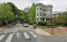 A google maps view of Petrillo Square. A three decker with apparently six units (two vertical stacks of bay windows letting in warm sun) face the marker put in place to honor Peter Petrillo. The street address is Magazine and Chestnut, Cambridge, MA.
